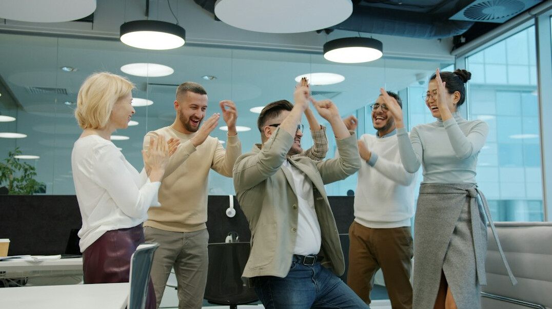 team stretching in office
